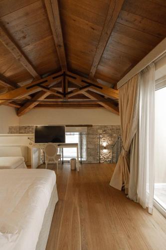 a bedroom with a bed and a wooden ceiling at Hotel & Residenza 100 Torri in Ascoli Piceno