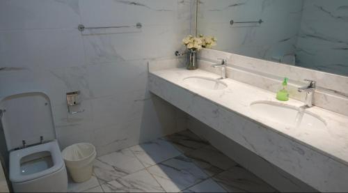 łazienka z 2 umywalkami i toaletą w obiekcie PRIVATE ROOM WITH WASHROOM AND BALCONY w Dubaju