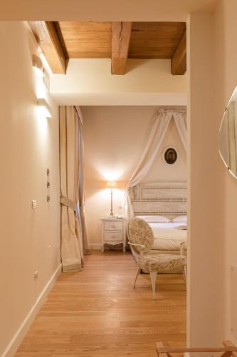 a bedroom with a bed and a chair at Hotel & Residenza 100 Torri in Ascoli Piceno