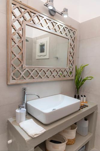 a bathroom with a sink and a mirror at Anemosyrma in Agia Irini Milos