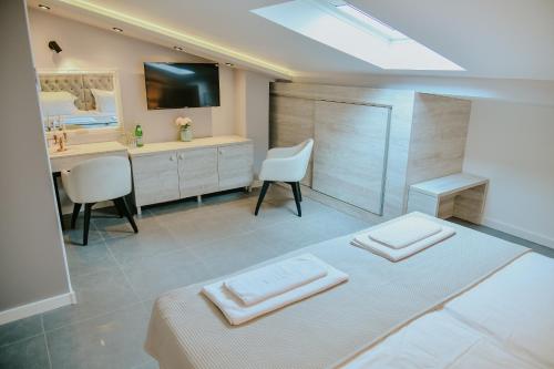 a bathroom with a bed with two towels on it at Vazdušna Banja in Niš