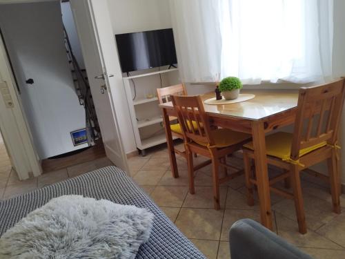 ein Esszimmer mit einem Tisch, Stühlen und einem TV in der Unterkunft Apartment Marta in Split