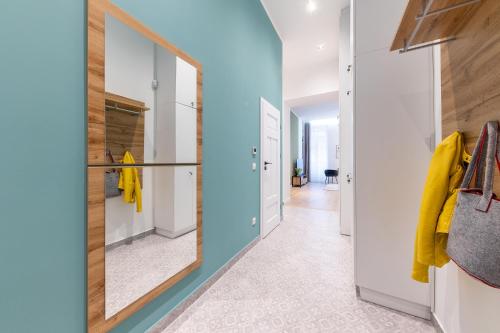 a dressing room with a mirror and a hallway at Izabella66 apartment in Budapest