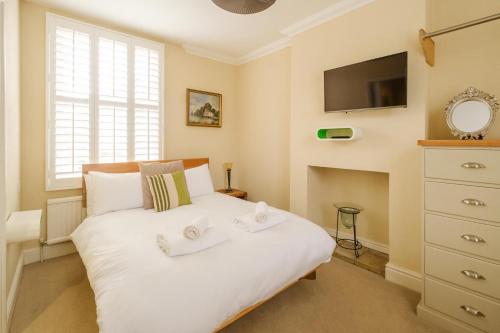 a bedroom with a bed with two towels on it at Tanyard House in Woodbridge