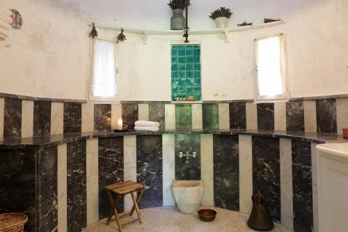 a room with a black and white stripped wall at Nisanyan Hotel in Selcuk