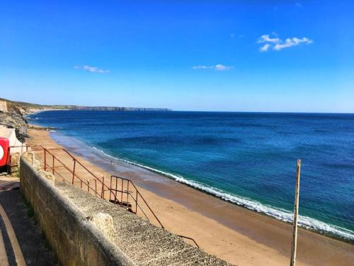 a view of a beach with the ocean at Guest Suite in Porthleven With Private Garden in Helston