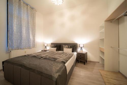 ein Schlafzimmer mit einem großen Bett und einem Nachttisch in der Unterkunft Stilvolle FeWo Augusta III in Görlitz
