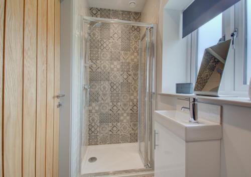 a bathroom with a shower and a sink at Field View in Hindolveston