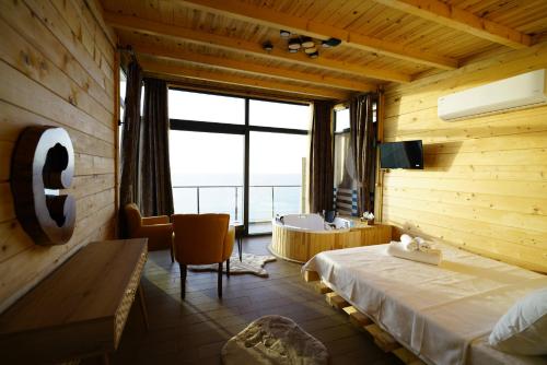 a bedroom with a bed and a desk and a window at Venek Viila Suit in Pazar