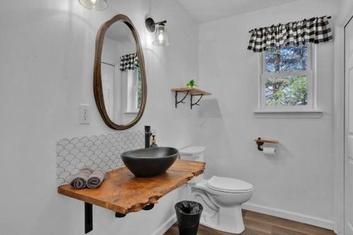 a bathroom with a bowl sink and a mirror at Pool Table - Game Room - Spacious Home in Poconos in Pocono Summit