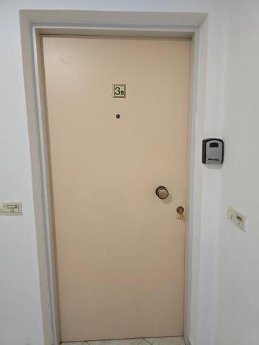 a white door with the number eighteen on it at University Apartment in Heraklio