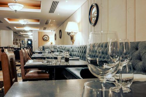 a row of wine glasses on a table in a restaurant at Doubletree By Hilton London - Greenwich in London