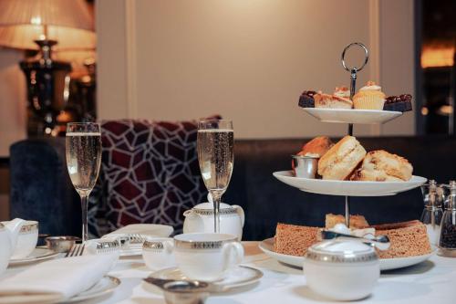 a table with glasses of champagne and a tray of food at Doubletree By Hilton London - Greenwich in London