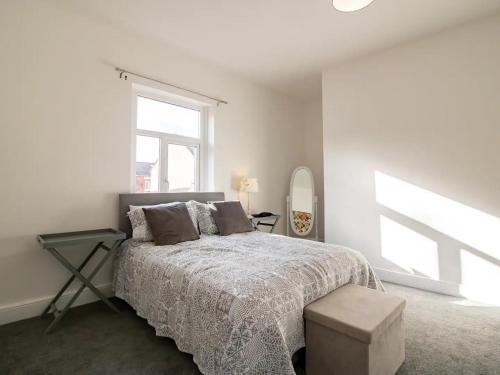 a white bedroom with a bed and a window at Half a mile to Beamish Museum Pass the Keys in Beamish