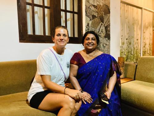 a man and a woman sitting on a couch at The Mango Leaf in Matara