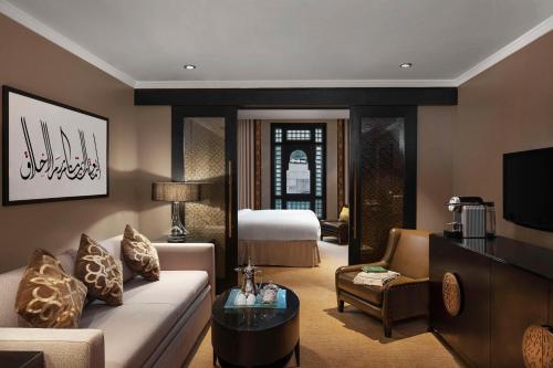 a living room with a couch and a bed at Sofitel Shahd Al Madinah in Medina