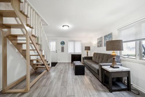 a living room with a couch and a staircase at Channel Lake Getaway home in Antioch