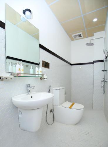 a bathroom with a sink and a toilet and a mirror at CROWN REGENCY- BADULLA in Badulla