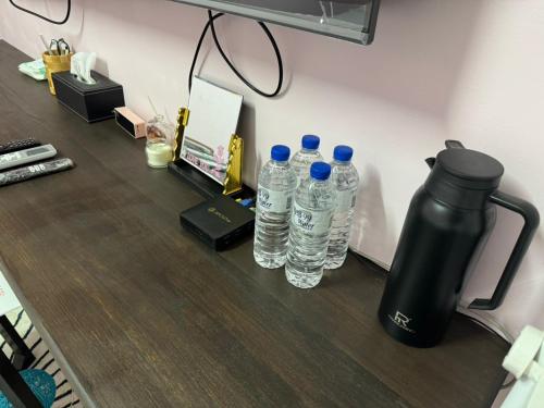 a group of water bottles sitting on a desk at Lukang Hung-shiu Homestay in Lugang
