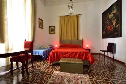カターニアにあるA Casa Di Lauraのベッドルーム1室(ベッド1台、テーブル、椅子付)