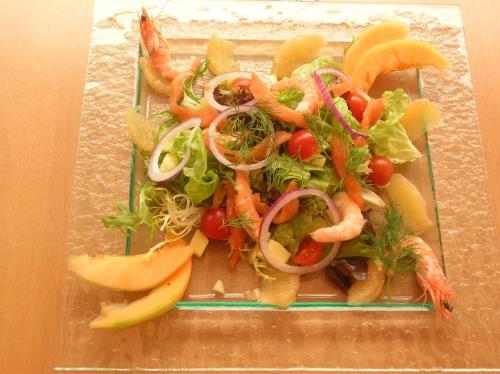 a plate of vegetables and fruits on a table at Kyriad Direct Haguenau in Haguenau