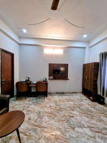 a meeting room with a table and chairs and a tv at Hotel Sangam View in Prayagraj