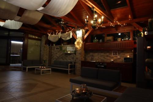 a living room with a couch and a table at Barackos Wellness Villa Fót in Fót