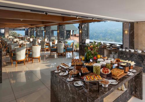 a buffet of food on a table in a restaurant at The Grand Cliff Resort Munnar in Viripara