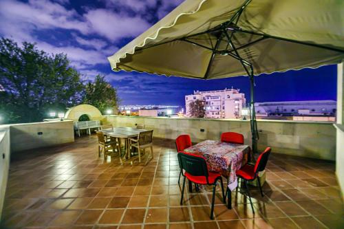 a patio with a table and chairs and an umbrella at Coffee time hotel in Baku