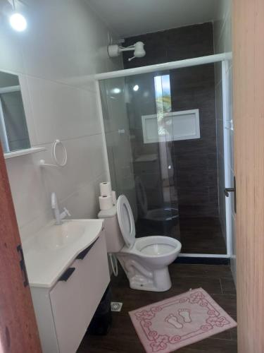 a bathroom with a toilet and a sink and a shower at Pousada Pé Na Areia in Arraial do Cabo