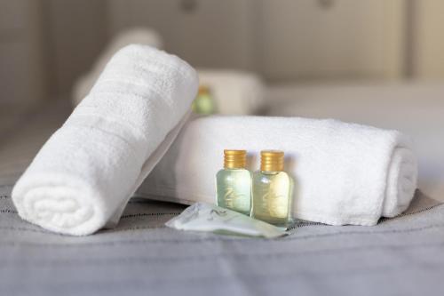 a hotel room with towels and two bottles of soap at Gernika Suite in Guernica y Luno