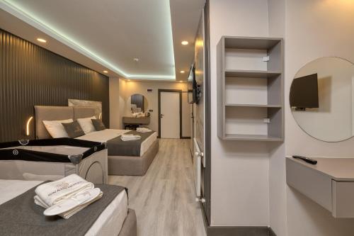 a hotel room with two beds and a tv at Swans Hotel Old City Grand Bazaar in Istanbul