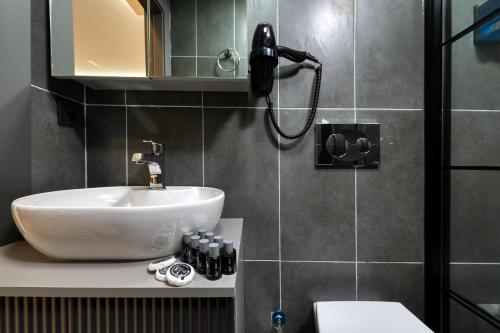 a bathroom with a sink and a shower at Swans Hotel Old City Grand Bazaar in Istanbul