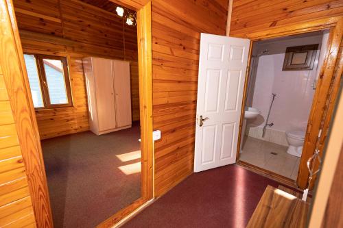 a bathroom with a toilet in a wooden room at Cənnət Məkən Göygöl in Goygol