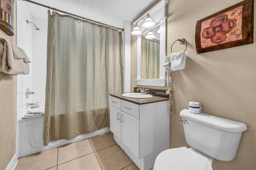 a bathroom with a toilet and a sink and a shower at Grand Panama 1-303 in Panama City Beach