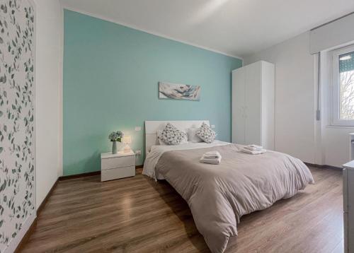 een slaapkamer met een bed en een blauwe muur bij Casa Felicity Verona in Verona