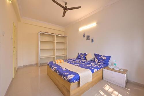 a bedroom with a bed and a ceiling fan at MERCURY VILLA ll 4BHK ll PRIVATE SWIMMING POOL in Lonavala