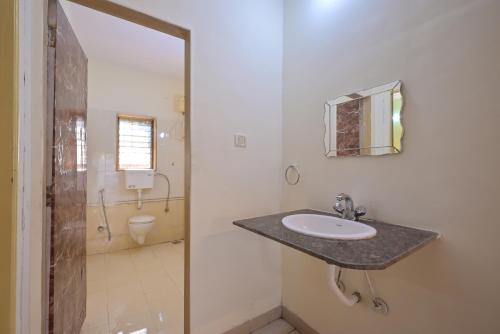 a bathroom with a sink and a toilet at MERCURY VILLA ll 4BHK ll PRIVATE SWIMMING POOL in Lonavala