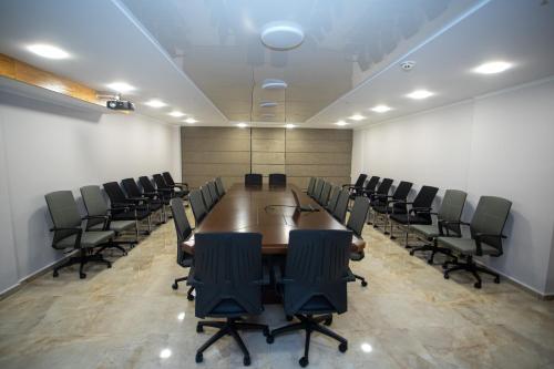 a conference room with a long table and chairs at Hotel Black Sea in Batumi