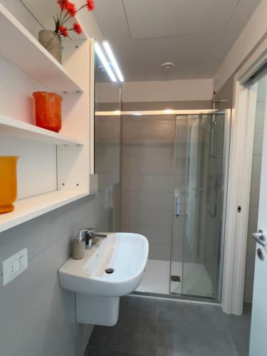 a white bathroom with a sink and a shower at Sacro Cuore Relais in Negrar