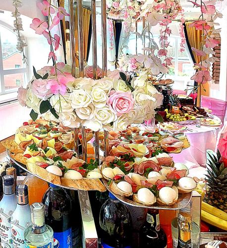 a table with several plates of food and flowers at The Continental Hotel, Derby in Derby