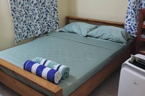 ein Bett mit einem Holzrahmen und Kissen darauf in der Unterkunft Dominica beach vacation rental in Roseau