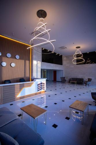 a living room with two tables and a couch at Hotel Black Sea in Batumi