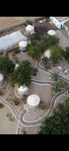 an aerial view of a park with trees and buildings at Auberge oued Illij in Atar