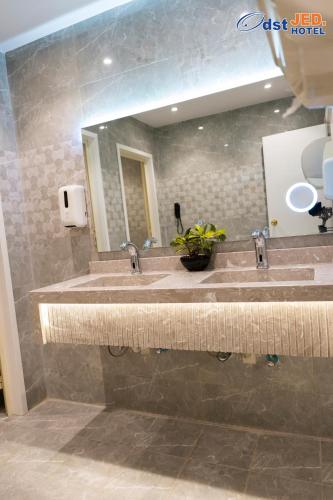 a bathroom with two sinks and a mirror at Odst Jeddah in Jeddah