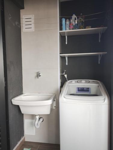 a small bathroom with a toilet and a sink at Piscine Resort Brás in Sao Paulo