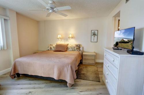 Schlafzimmer mit einem Bett und einem Deckenventilator in der Unterkunft Land's End 1-202 Bay Front in St Pete Beach