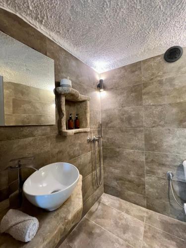 a bathroom with a white sink and a shower at Pool Villa Lagonisi 5min from Beach in Koropíon