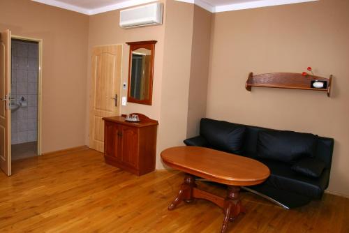a living room with a couch and a table at Penzion FAJN *** in Pardubice