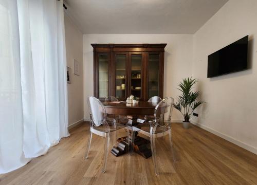 a dining room with a wooden table and chairs at CLASSY HOMES - A due passi dal mare in Sanremo